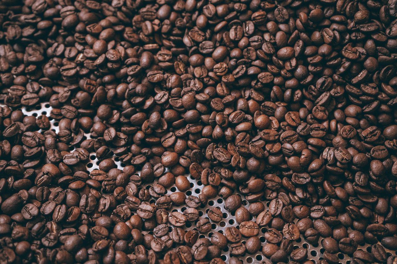 A detailed close-up image of aromatic roasted coffee beans, perfect for coffee enthusiasts.